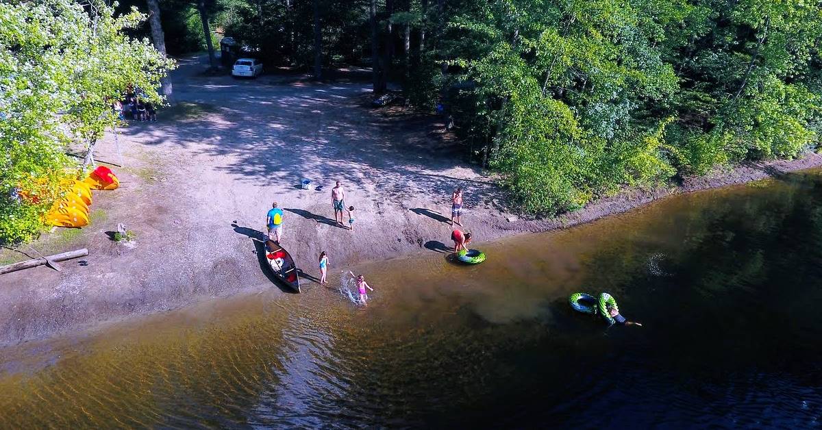 aerial view of kids getting in schroon river with tubes and rowboat