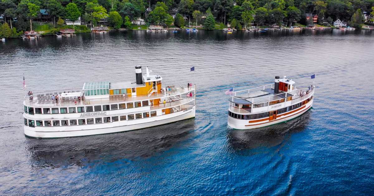 two large cruise boats on a lake
