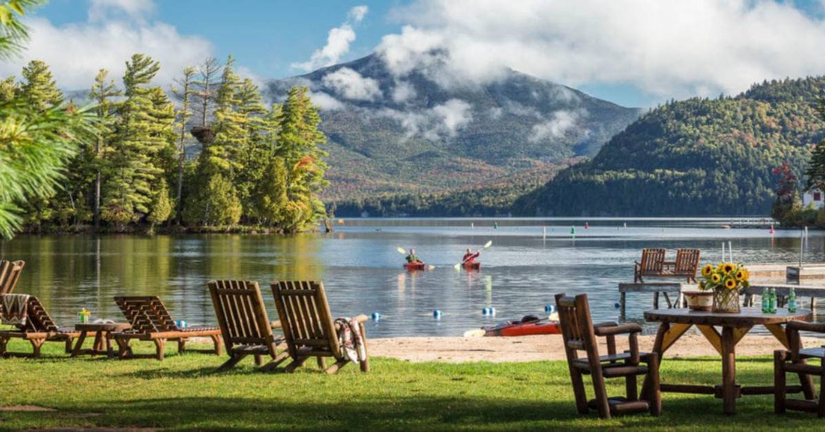 two people kayaking from a resort onto a lake
