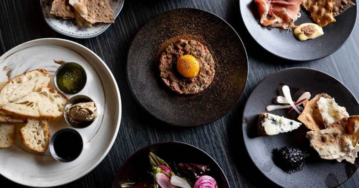 Image shows the variety of food options on the menu and the snack- size portions that are perfect to pair with a late night drink. 