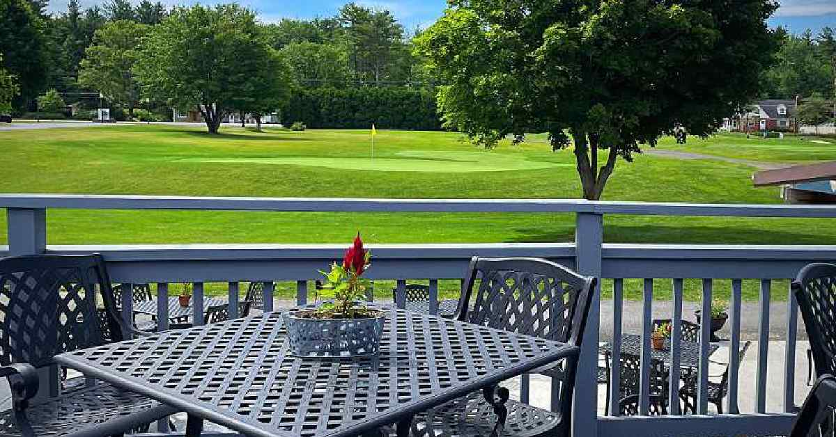 Image shows view from the patio of The Iron's Edge overlooking the connecting golf course. 