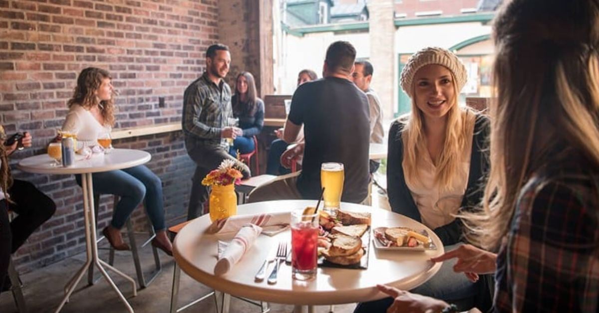 Image shows the high top tables that customers love to sit at while dining at Henry Street Taproom.