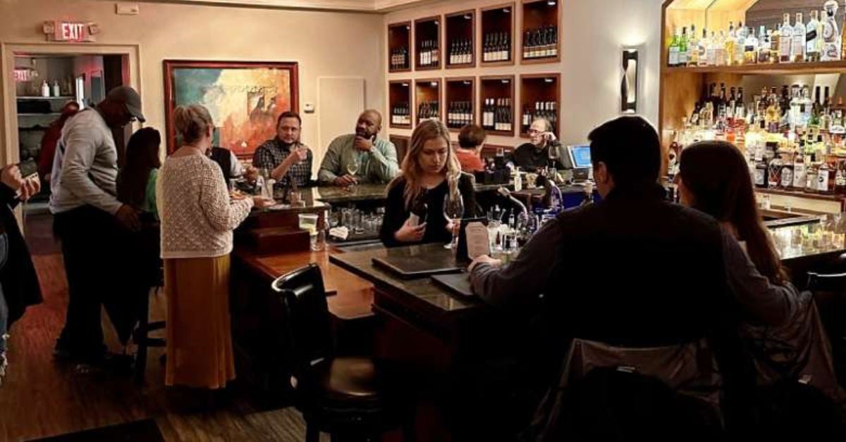 Image shows the indoor dining space and ambiance of The Wine Bar. 