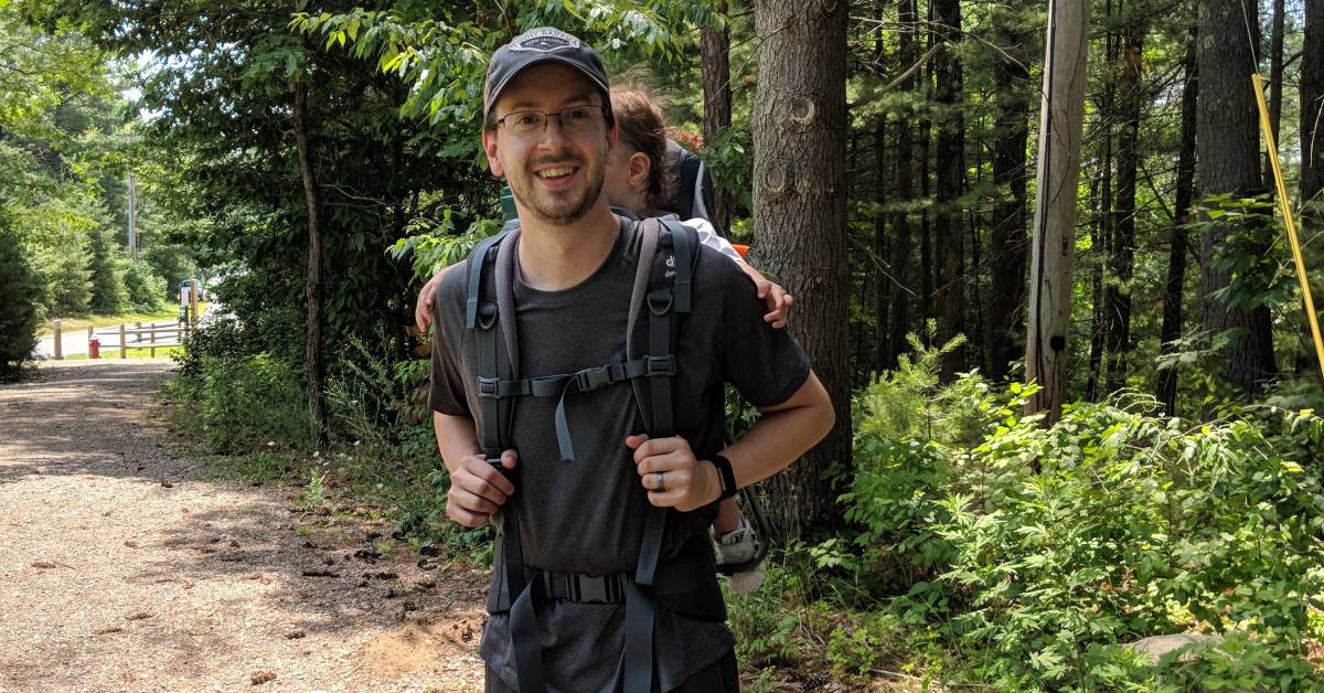 dad hiker with toddler on back