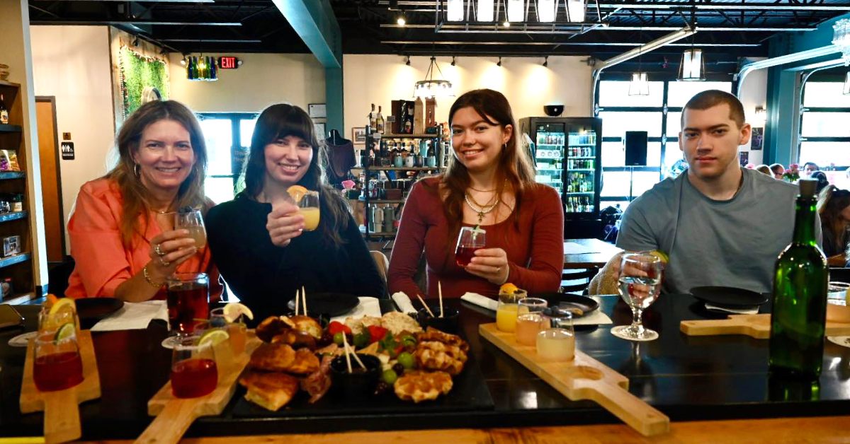 three women and a guy at a winery bar
