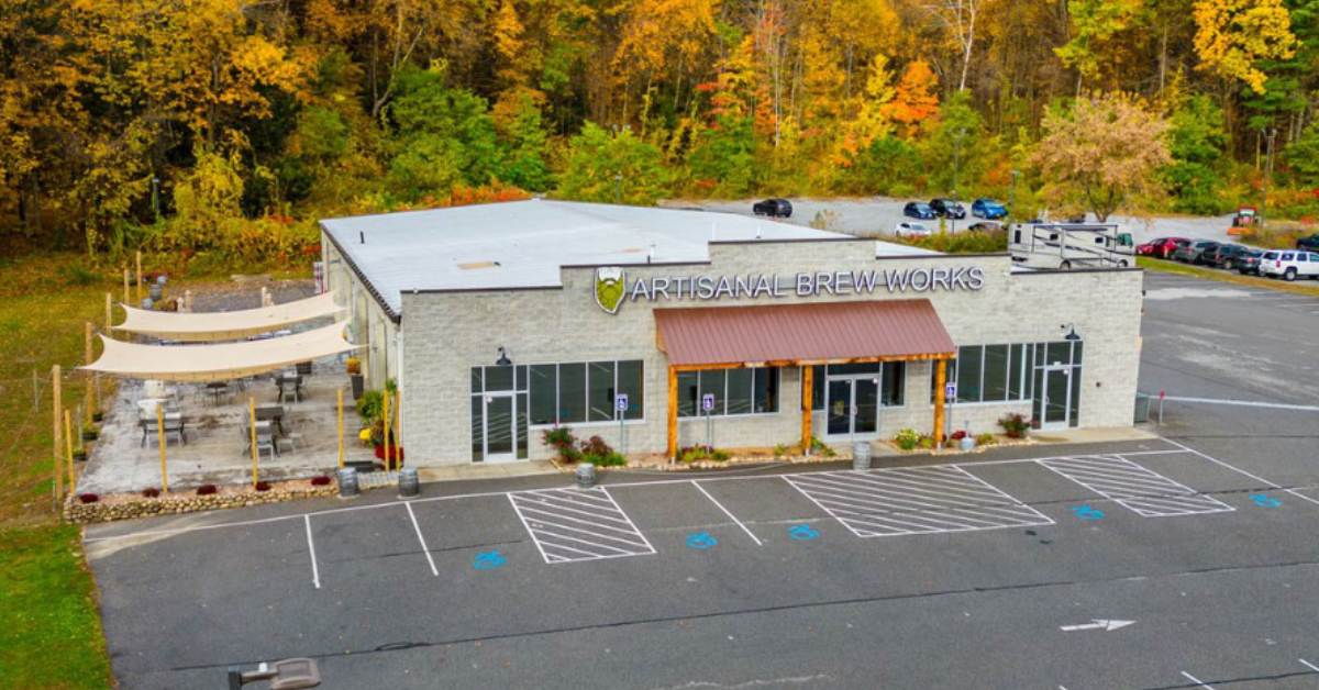 outside of artisanal brew works with fall colors on the trees