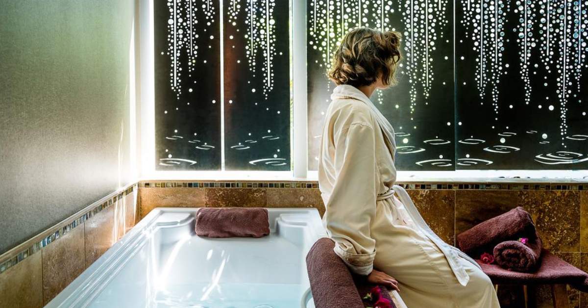 woman seated at spa tub