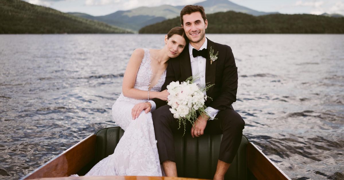 bride and groom in boat on a lake