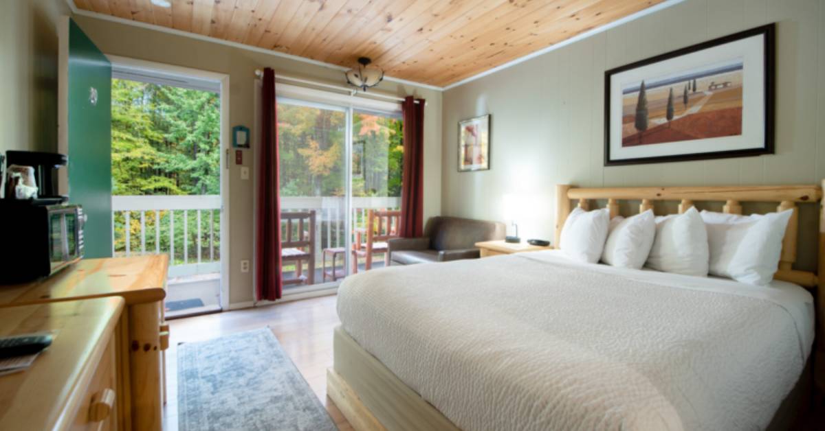 bedroom with fall foliage outside window