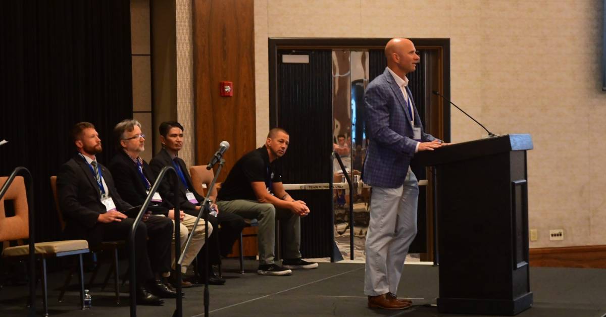 man speaks at podium 