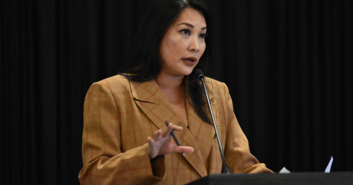 woman speaks at podium 