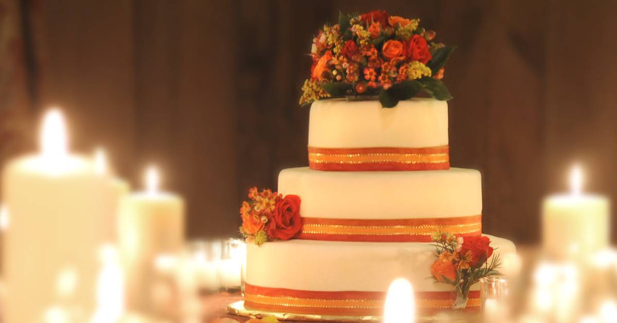 wedding cake surrounded by candles