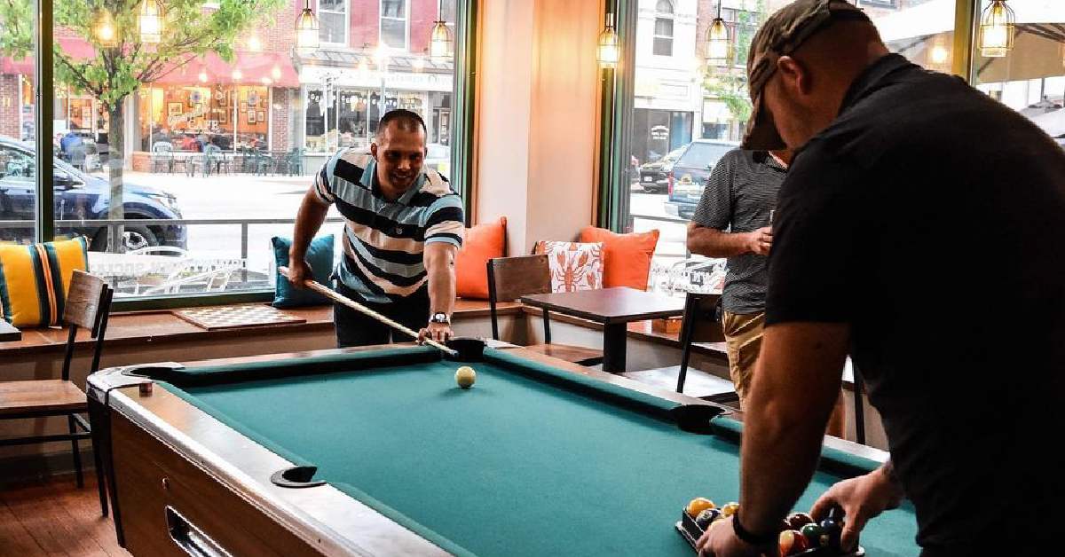 guys playing at a pool table