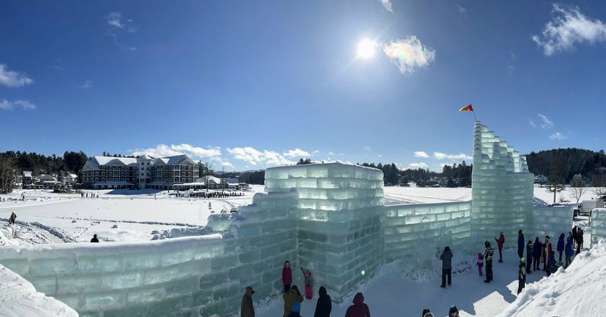 an ice block palace by a frozen lake in winter