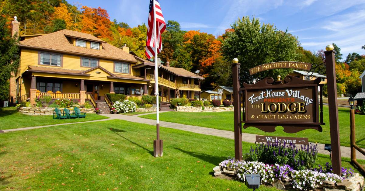 trout house village resort exterior with sign in the fall