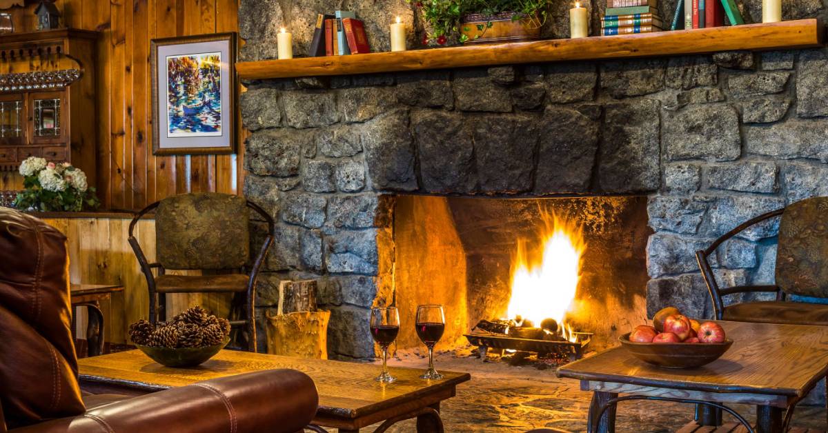 two glasses of wine by fire at lodge at garnet hill lodge