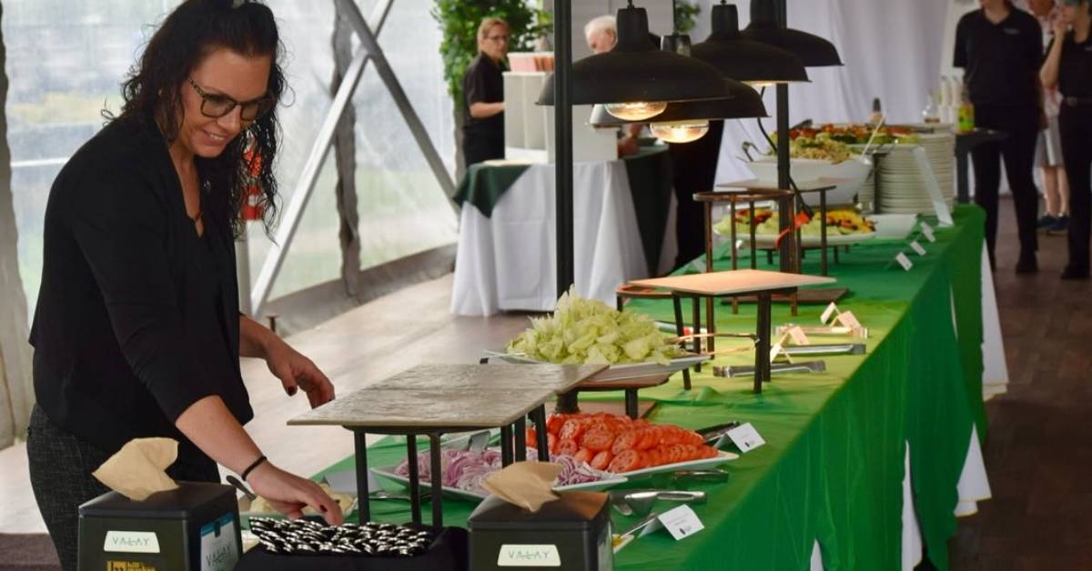 woman setting up buffet table at wedding