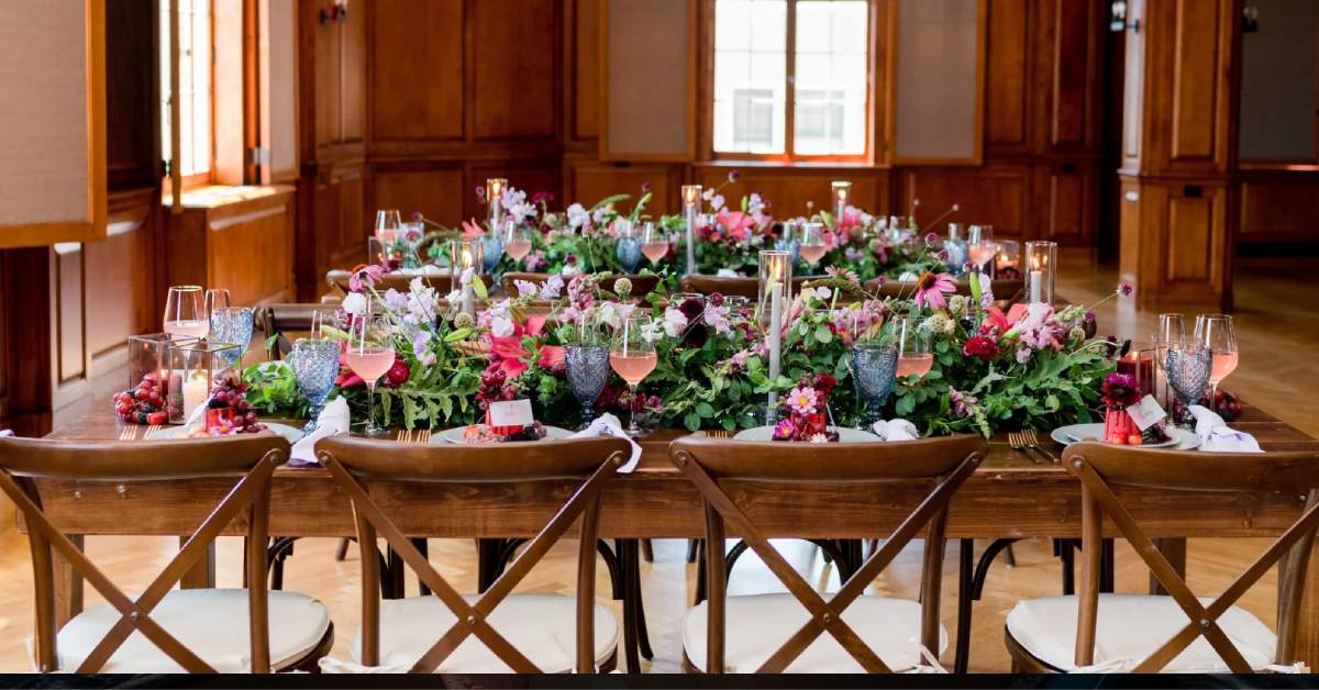 a table decorated with flowers, candles, and tableware for a wedding meal