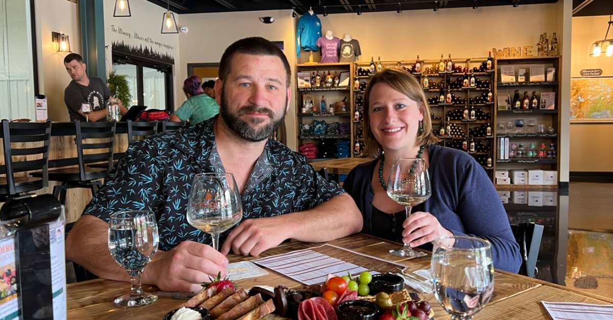 a man and woman at a table with wine glasses