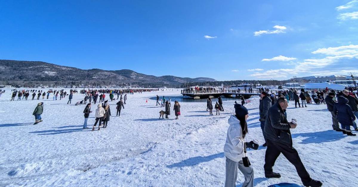 people walking on a frozen lake during a winter carnival