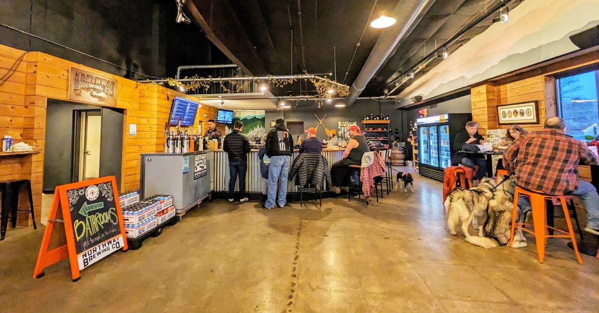 crowd inside a brewery with dogs