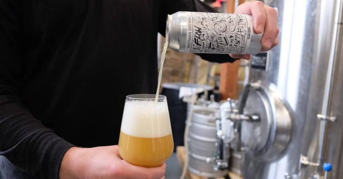 person pouring beer from can