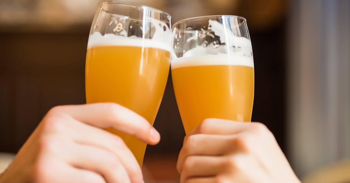 two glasses of beer cheersing
