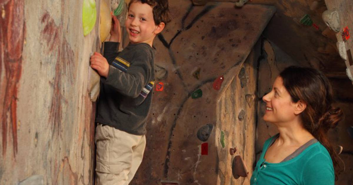 mom watching son rock climb