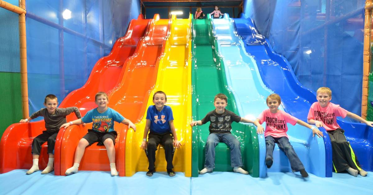 group of boys pose at end of slides at billy beez