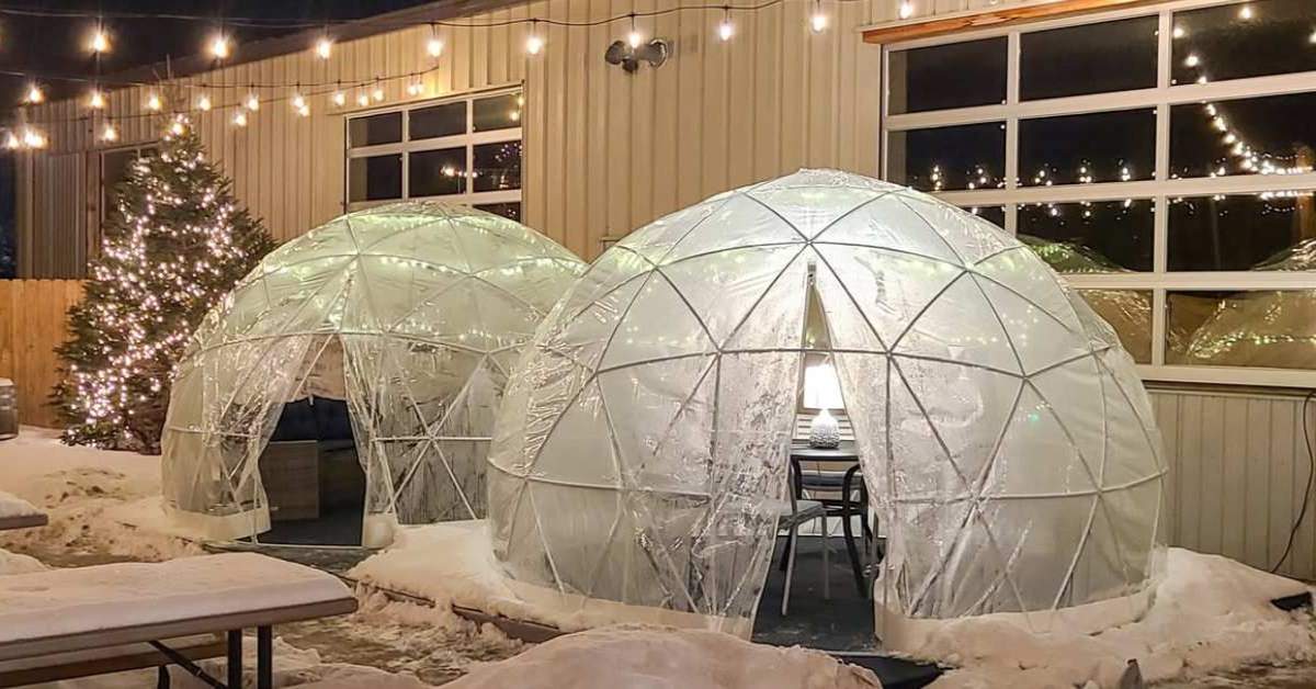 patio with outdoor igloos in the snow with lights