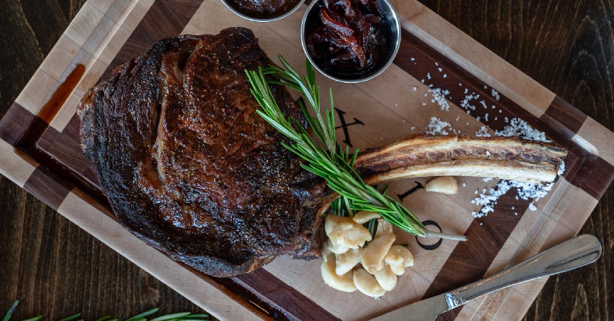 tomahawk steak on cutting board