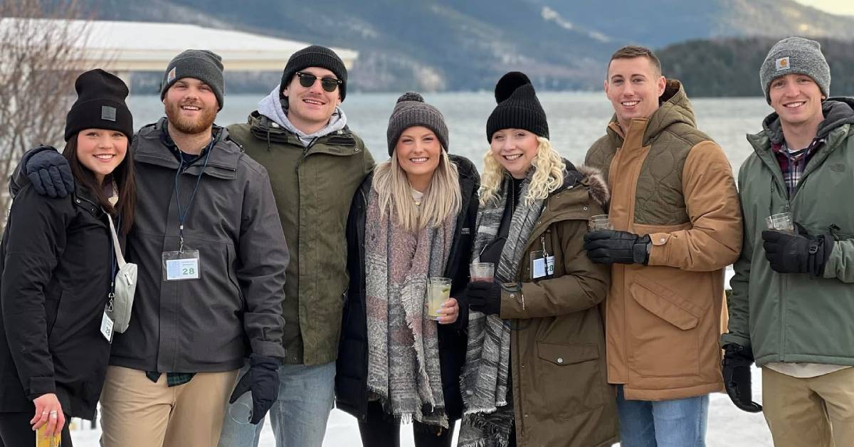 crowd with drinks in winter in front of lake george