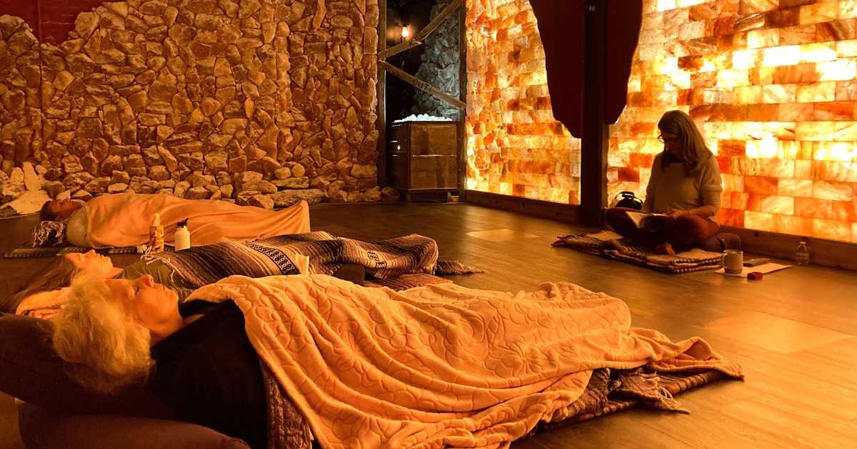 people resting in a salt cave wellness center