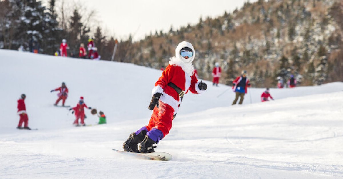 Santa on a snow board with other santa's close behind
