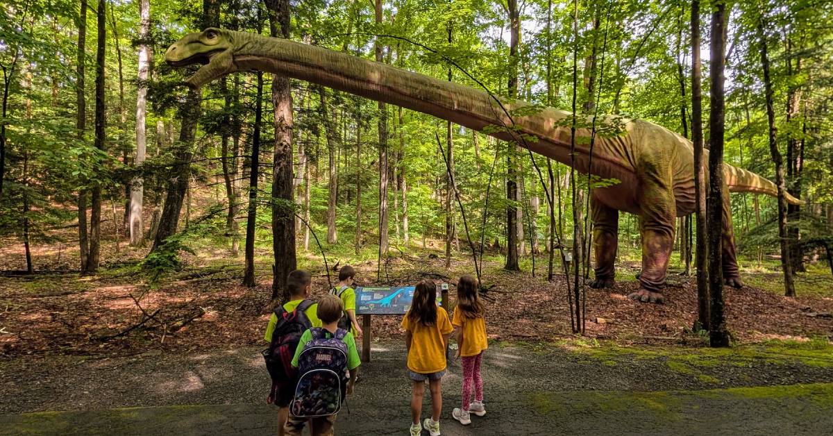 kids look at dinosaur at lake george expedition park