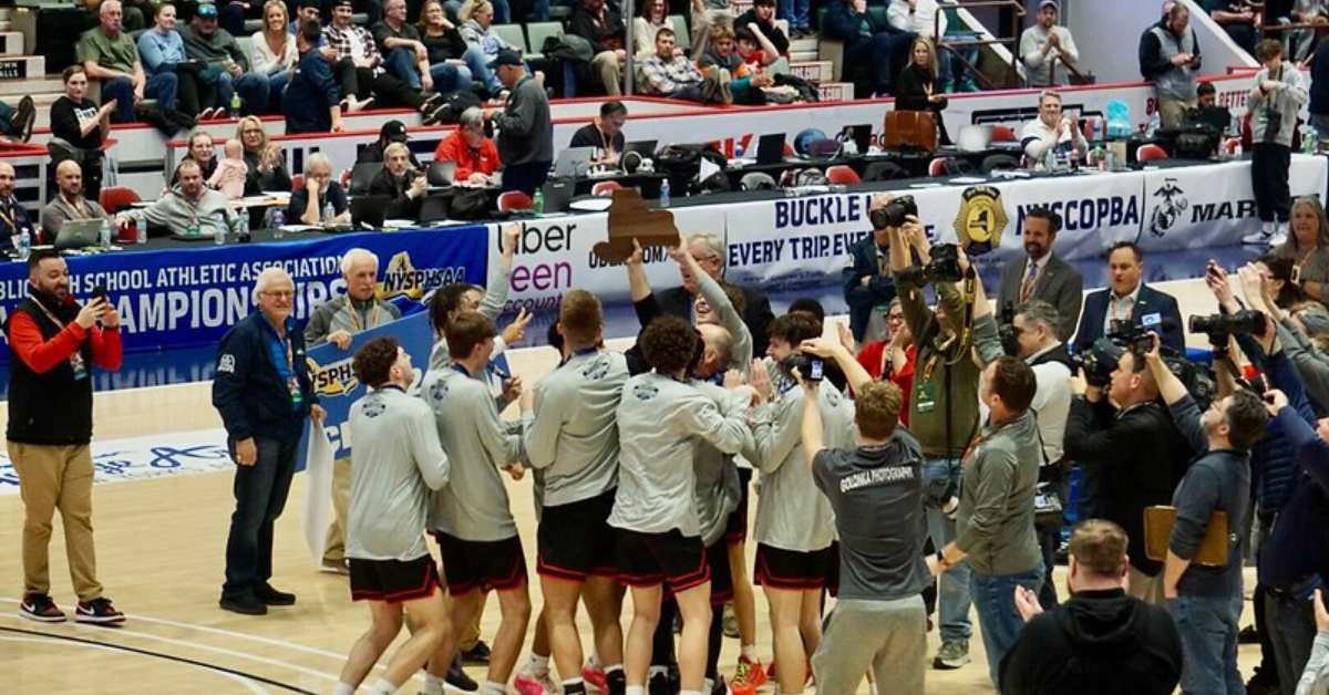 boy's high school basketball team celebrating on the court