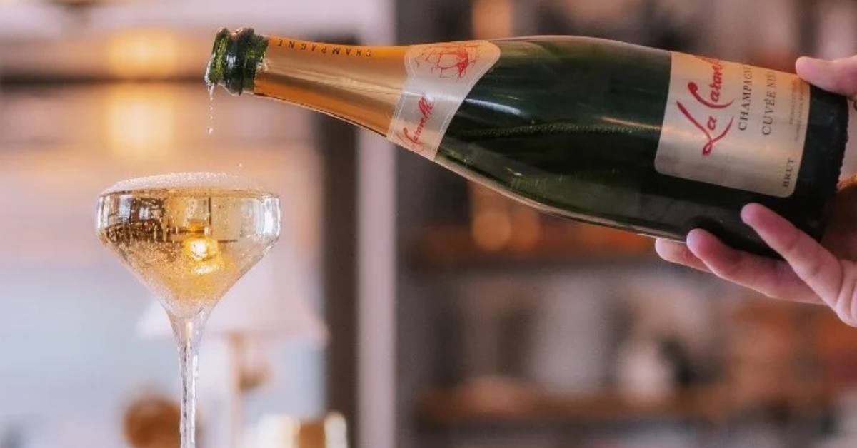 champagne being poured into a glass out of a bottle