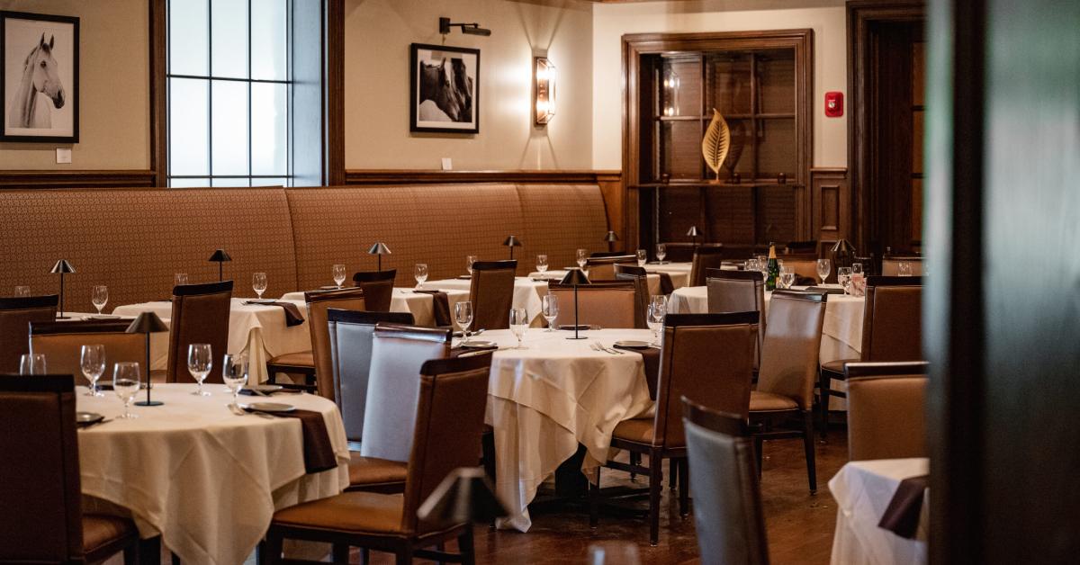 an upscale dining room with round tables
