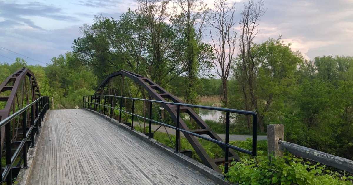 a historic bridge leading into a park