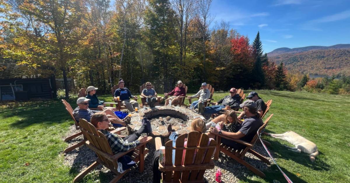 people gathered around fire pit in fall