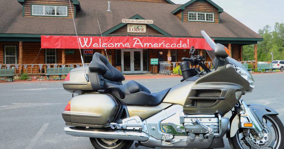 motorcycle parked in front of lake george escape campground