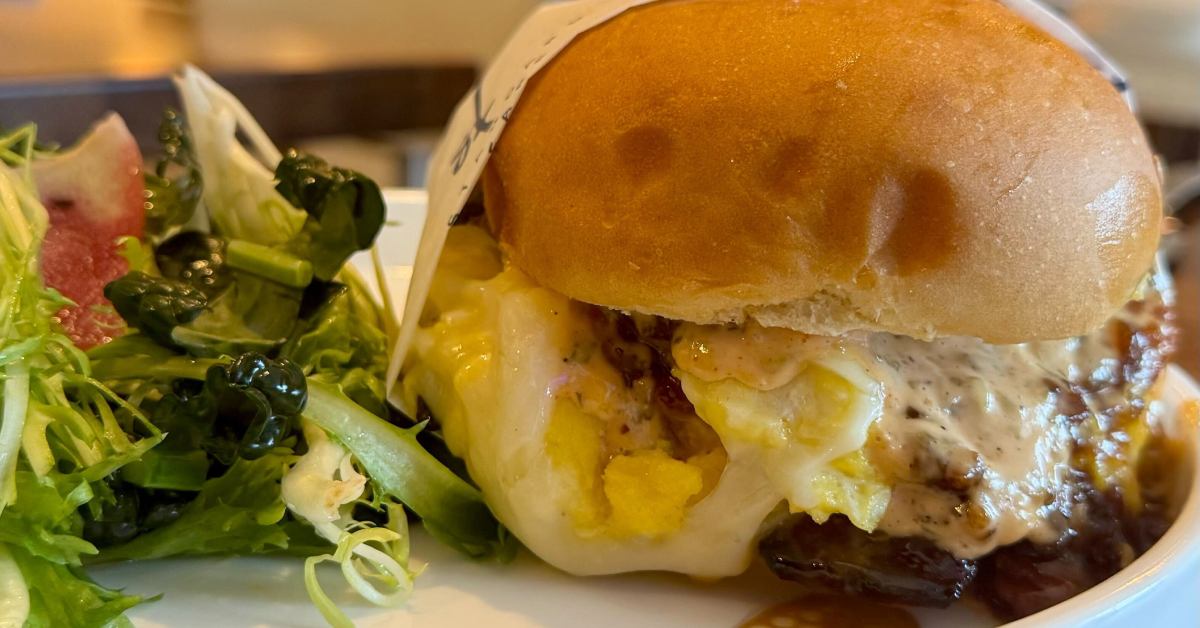 side salad on the left with breakfast sandwich with egg on the right