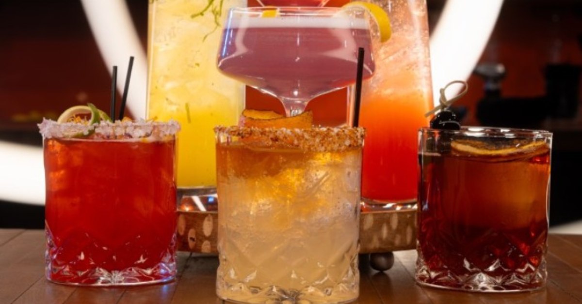 an assortment of cocktail drinks next to each other