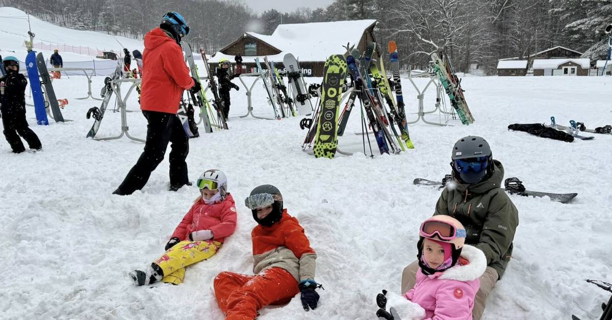 kids in snow at west mountain near ski lift and snowboards