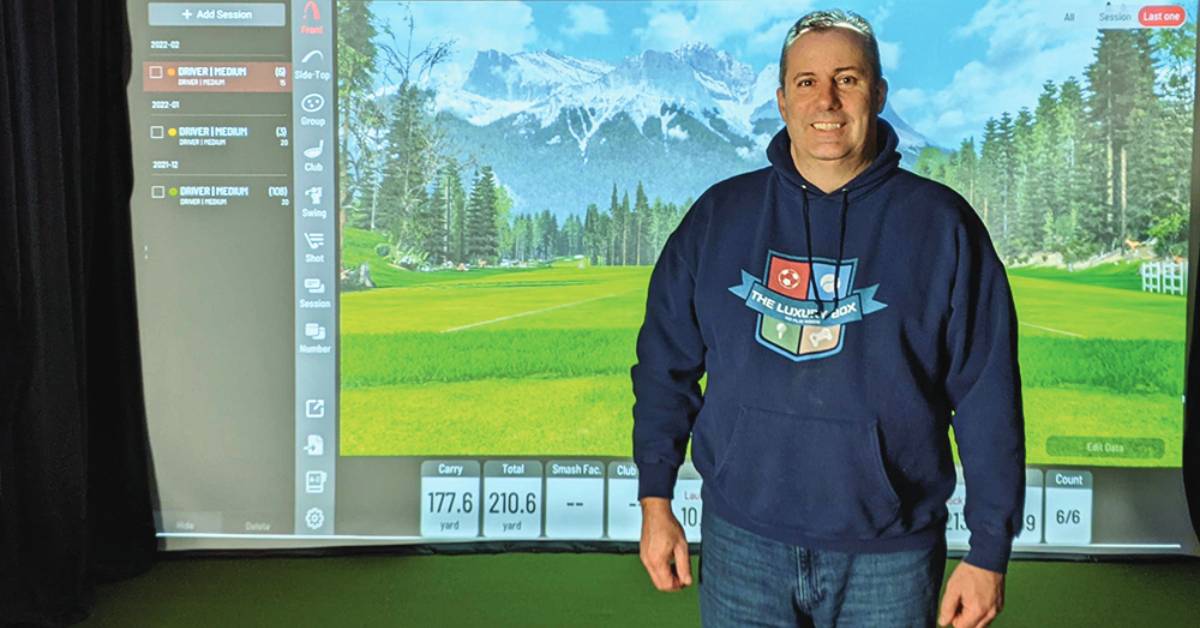 man standing in front of luxury box simulator