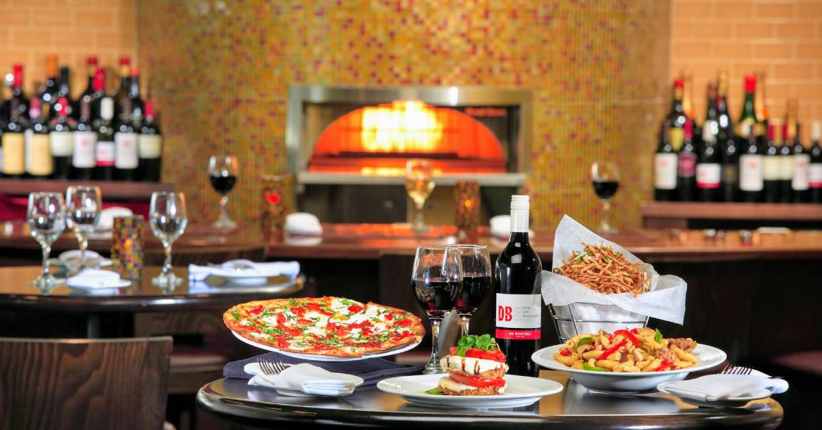 pizza and wine on a table in a restaurant