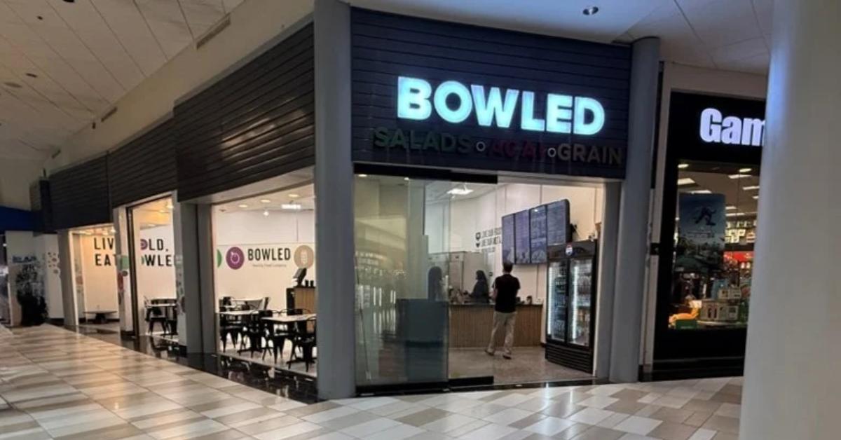 Sign that says Bowled on it with tables and chairs inside