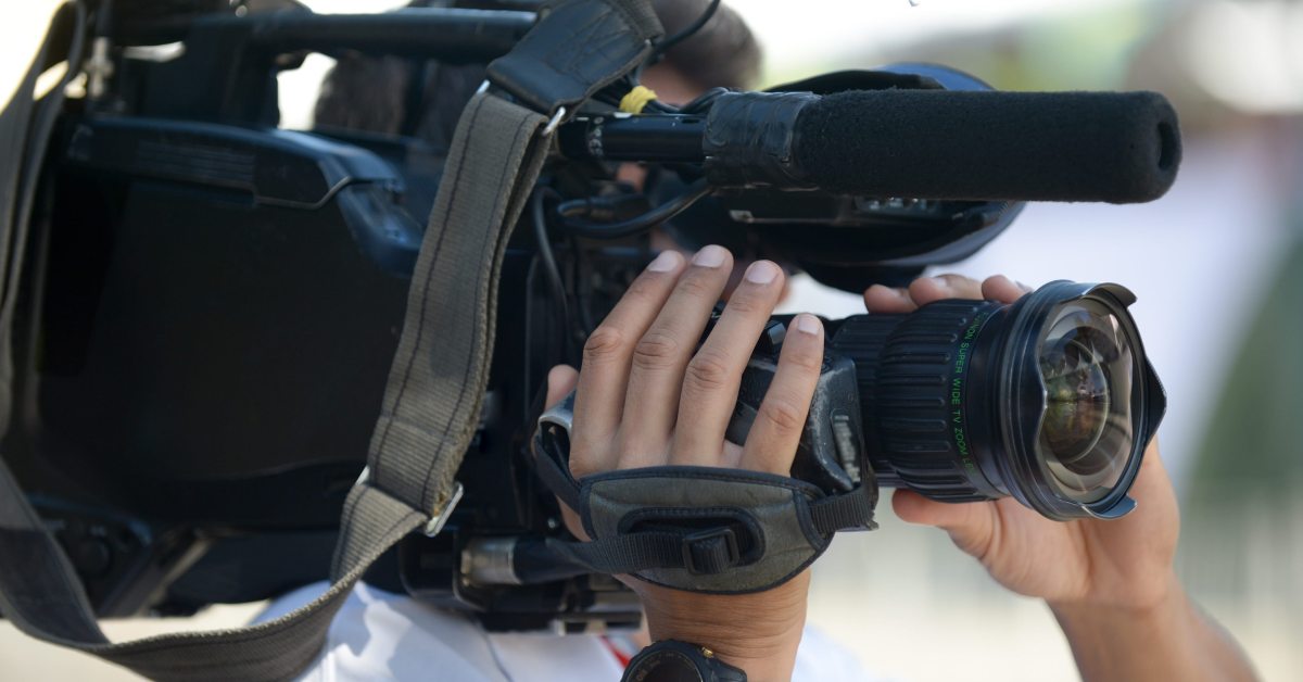 someone holding large camera