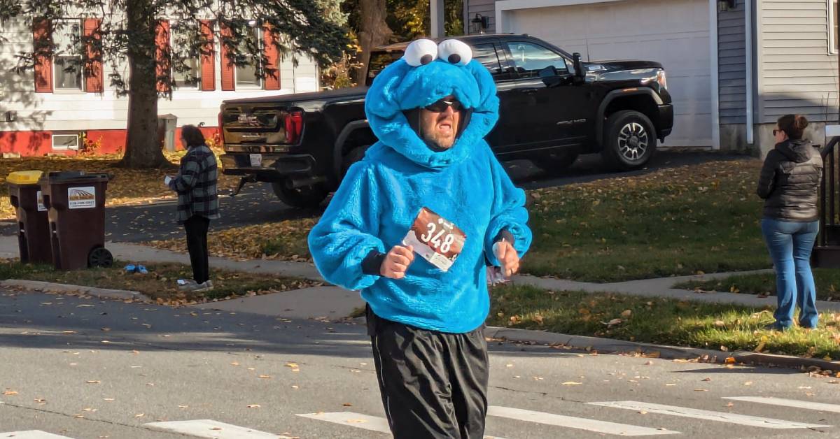 man running in cookie monster costume