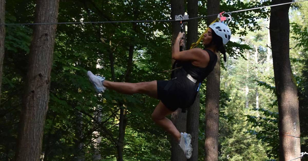 woman ziplining through the air